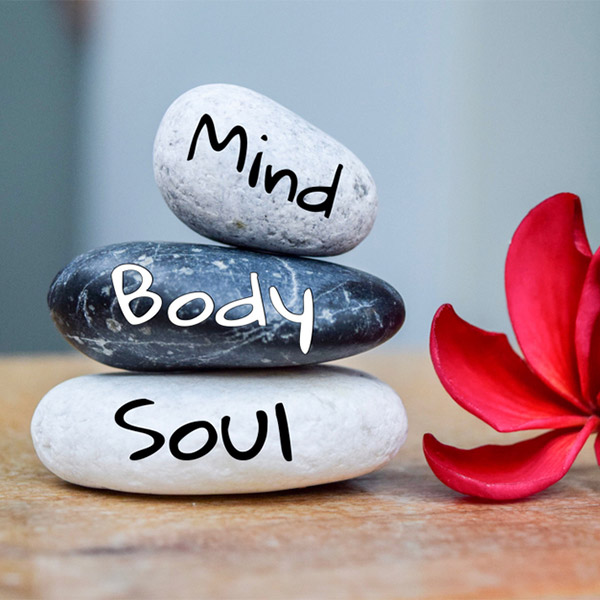 Stones with the words Mind, Body and Soul